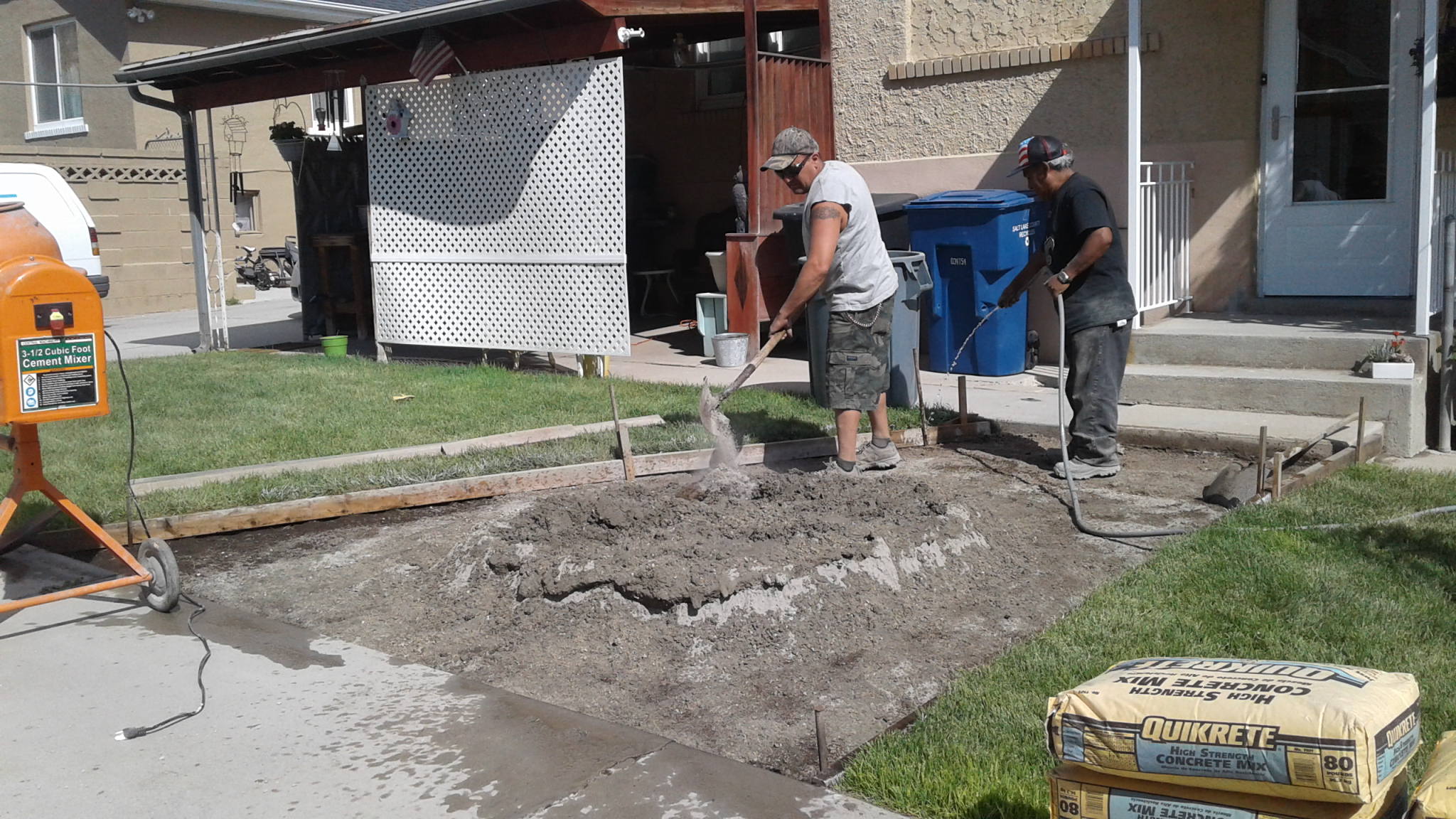 A couple of men that are standing in the dirt