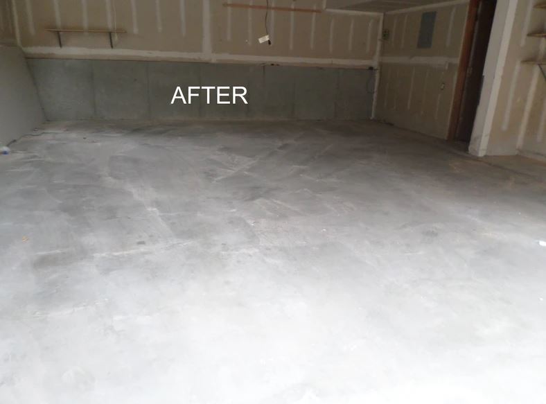 An empty garage with a white floor and a white wall