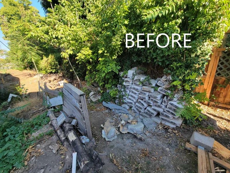 A pile of rubble sitting next to a forest