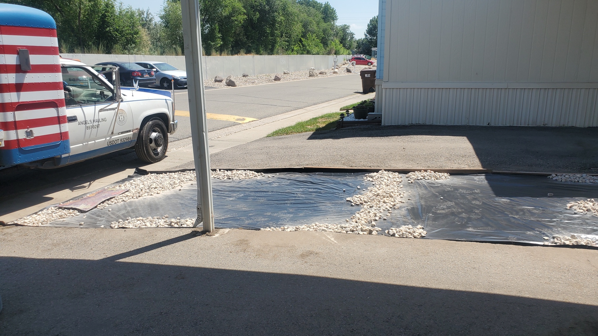 A truck is parked next to a puddle of water