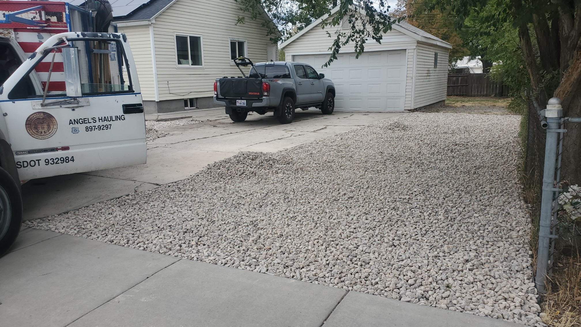 A truck parked in a driveway next to a house