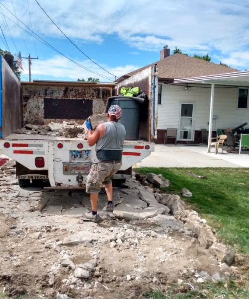 A man standing in the back of a truck